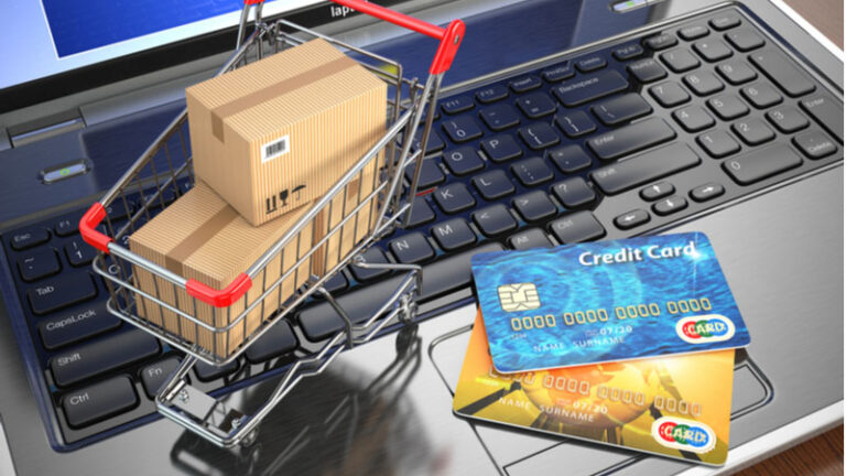 Ecommerce Shopping Cart And Credit Cards On Laptop Concept.jpg