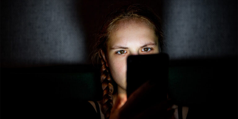 Teen Girl On Smartphone In Bed At Night.jpg