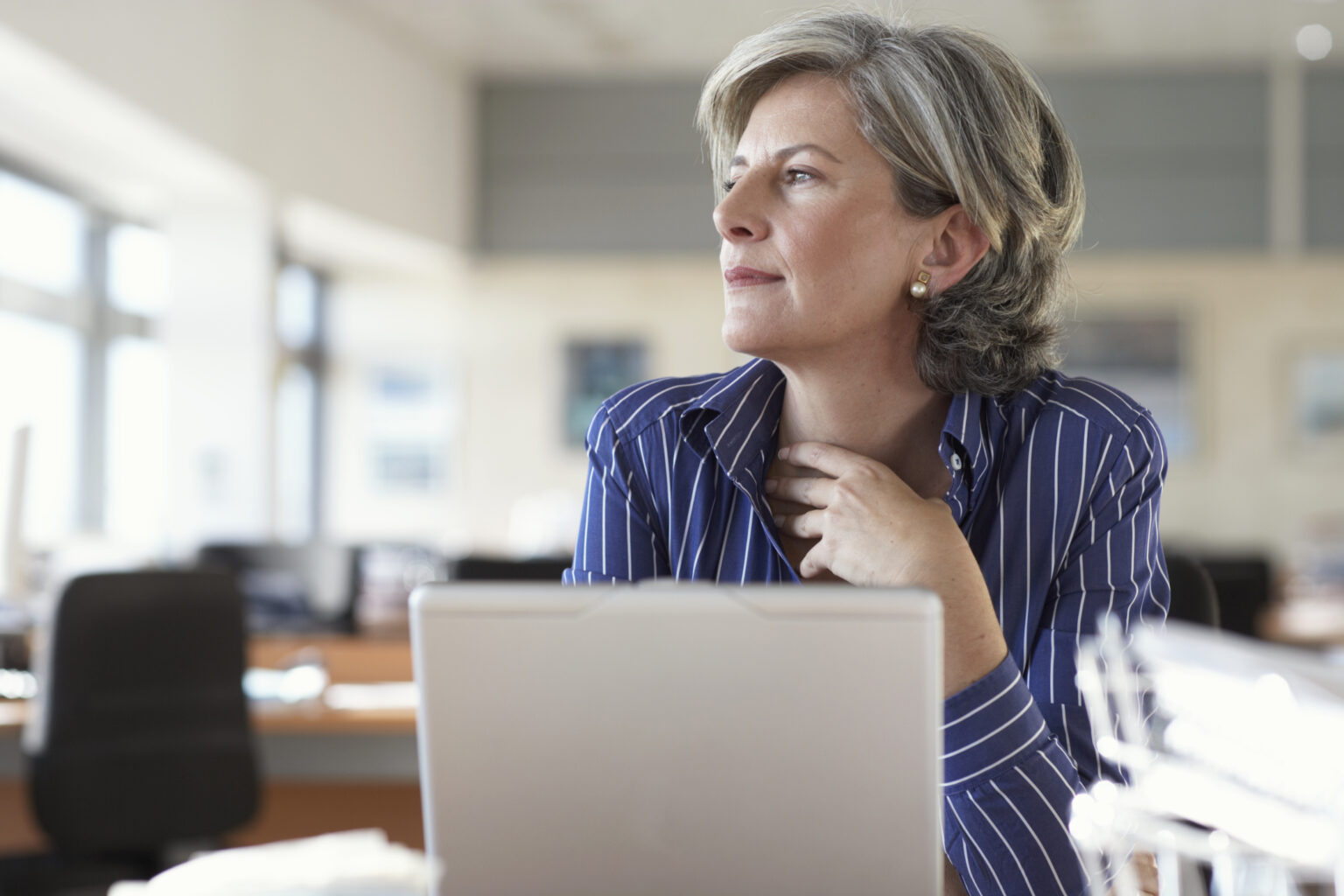 Mature Woman On Laptop Thinking And Looking Out Window.jpg
