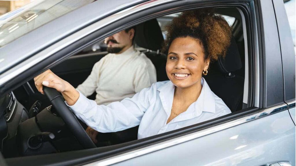 1 The Double Edged Sword Of Insurance Tracking Programs Smiling Woman In Car.jpg