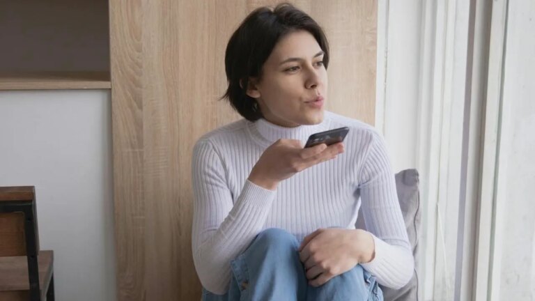 1 Check Out Easy Ways To Make Calls When Vision Is A Challenge Woman In White Turtleneck Speaking On Phone.jpg