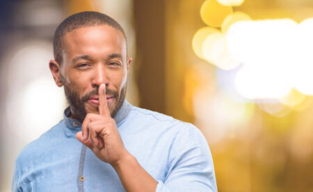 African American Man With Beard With Index Finger On Lips Ask To Be Picture Id1041761256.jpg