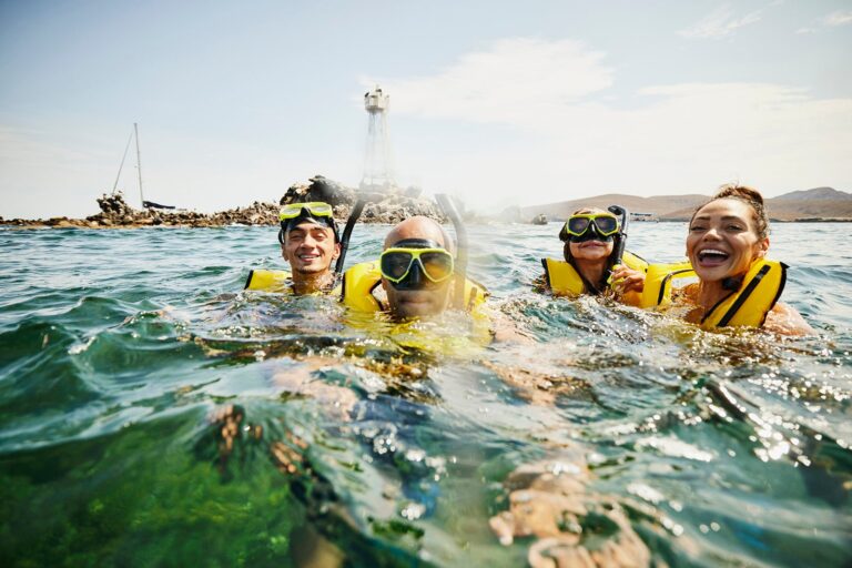 Smiling family on snorkeling tour on tropical summer vacation thomas barwick.jpg